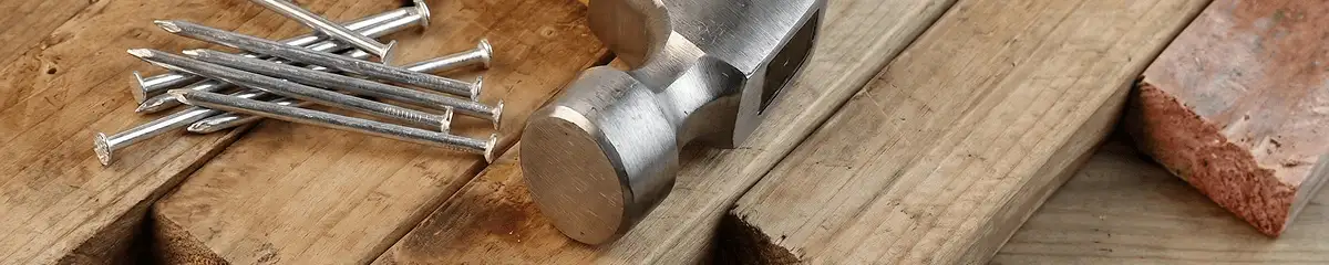 Hammer and nails on hardwood flooring boards in Sacramento, CA