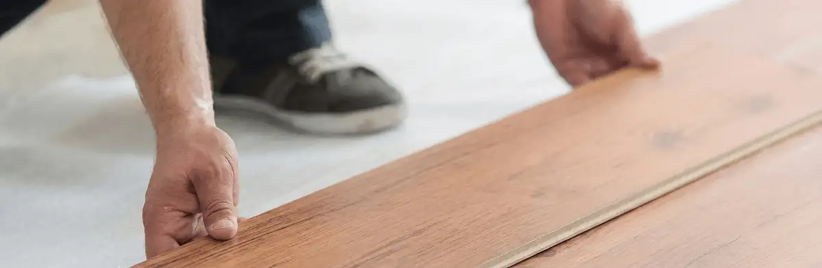 A professional installing laminate flooring in Sacramento, CA